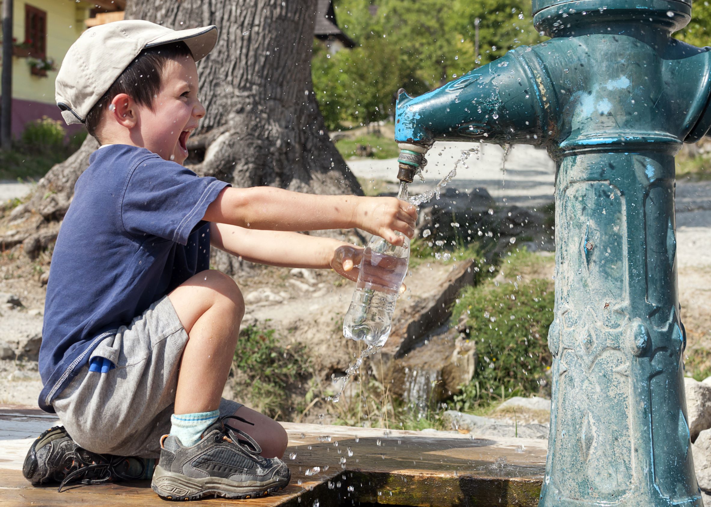 Happy Child Filling Water Bottle_Social Impact Management